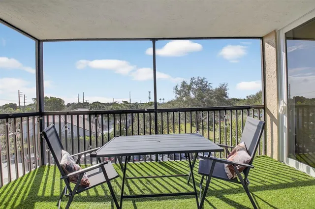 a view of a balcony with chairs