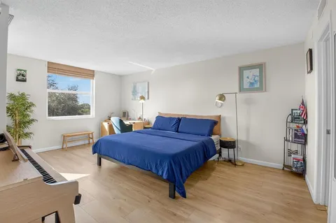 a bedroom with a bed and a table in it