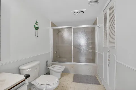 a bathroom with a toilet and a shower