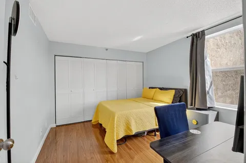 a bedroom with a bed and a table