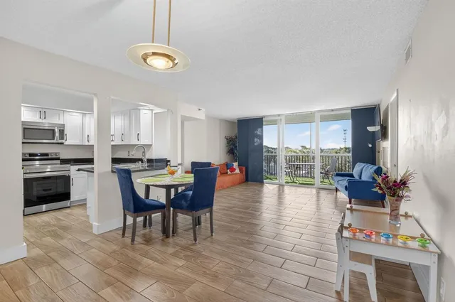 a view of a dining room with furniture and a wooden floor