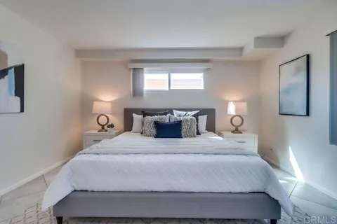 a bedroom with a bed and window