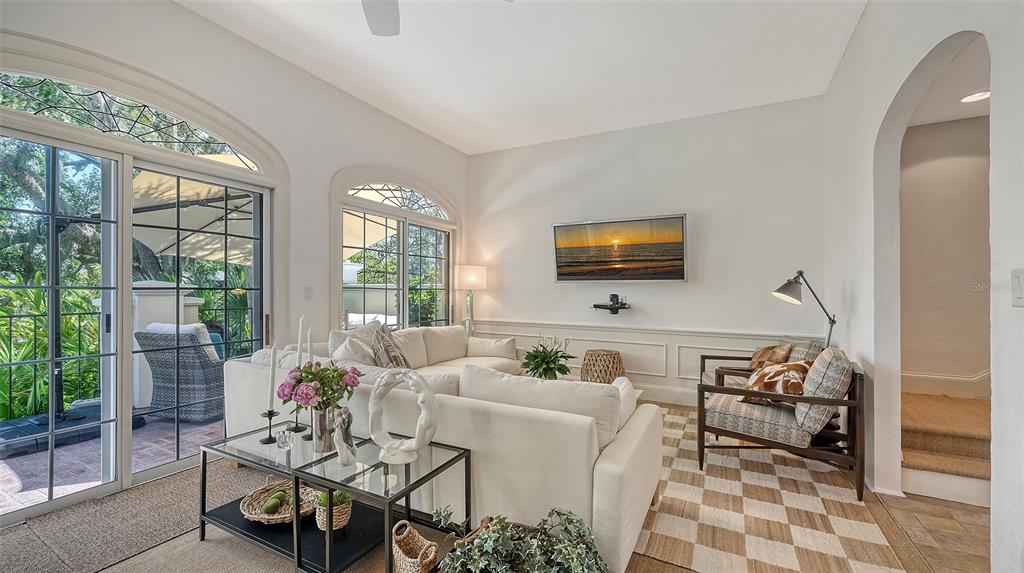 33 Bishopscourt Road, Unit 118 Osprey, FL 34229 - Photo 13 of 80 a living room with furniture and a flat screen tv