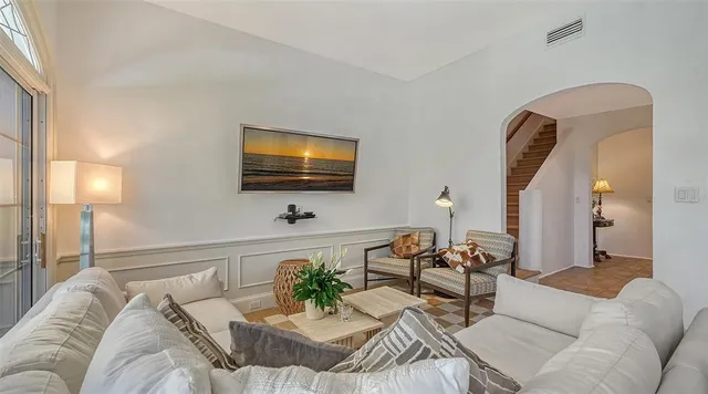a view of a swimming pool with a yard and palm trees