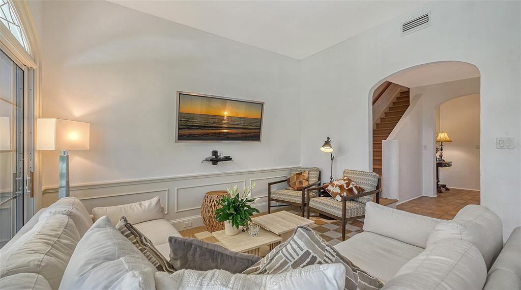 33 Bishopscourt Road, Unit 118 Osprey, FL 34229 - Photo 17 of 80 a living room with furniture and a flat screen tv
