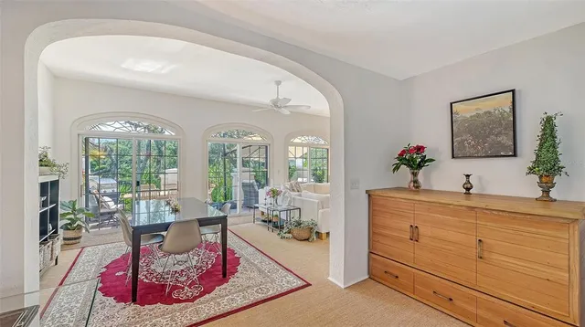 a living room with furniture and a floor to ceiling windows