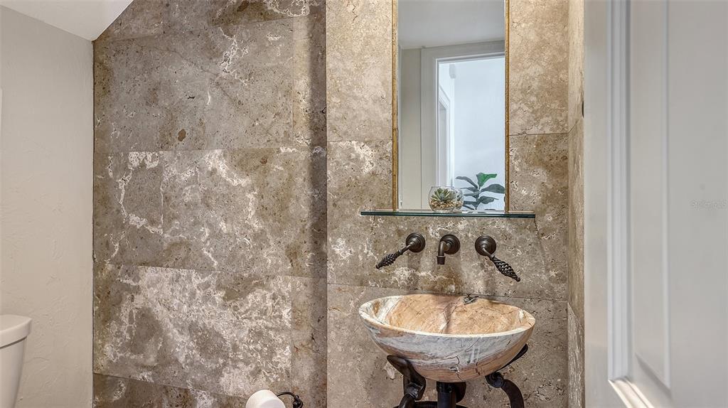 33 Bishopscourt Road, Unit 118 Osprey, FL 34229 - Photo 27 of 80 a bathroom with a sink a toilet and a mirror