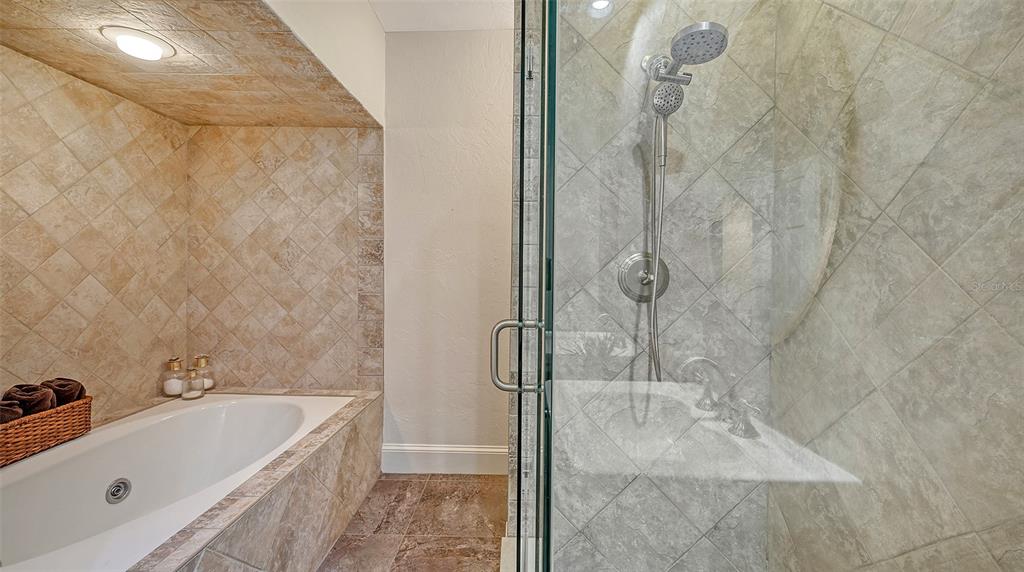 33 Bishopscourt Road, Unit 118 Osprey, FL 34229 - Photo 33 of 80 a bathroom with a tub a sink and shower