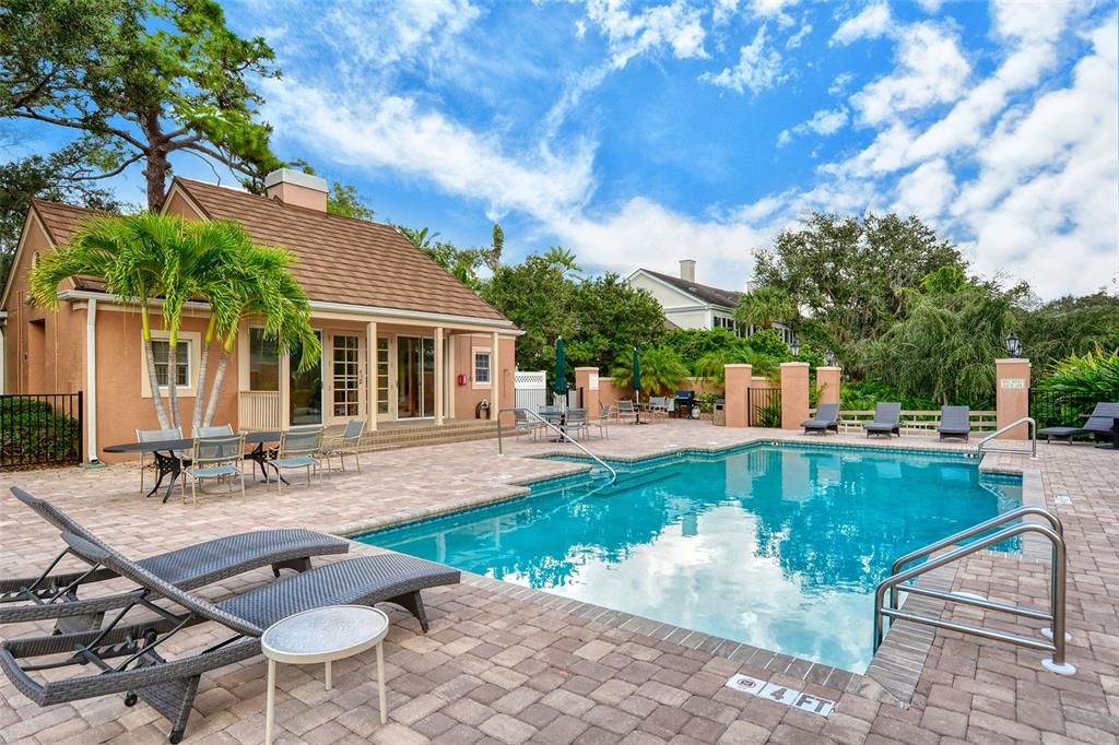 33 Bishopscourt Road, Unit 118 Osprey, FL 34229 - Photo 44 of 80 a swimming pool with outdoor seating and yard