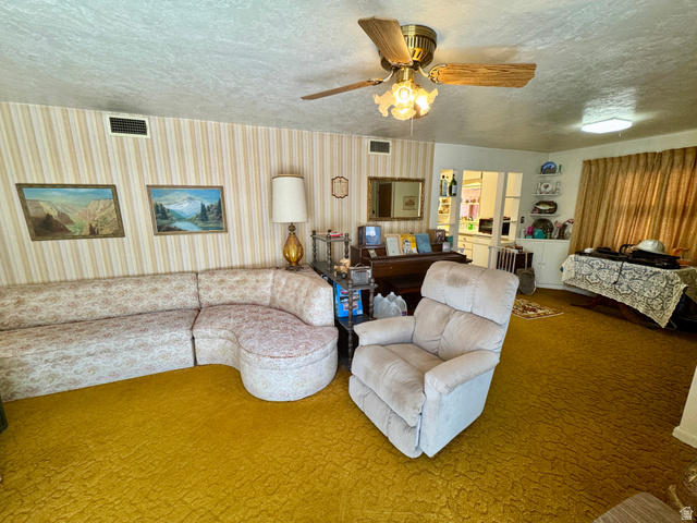 178 Walnut Lane Moab, UT 84532 - Photo 15 of 25 Living space featuring textured gold carpeting and striped wallpaper