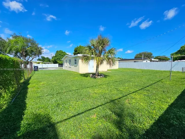 a view of a garden with a building in the background