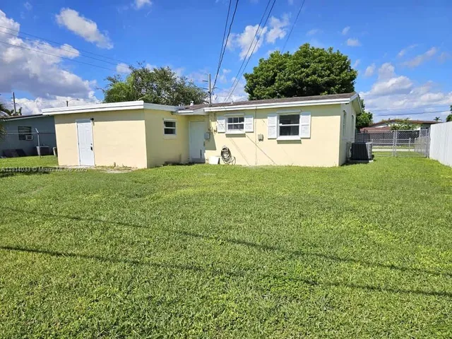 a view of a house with a back yard