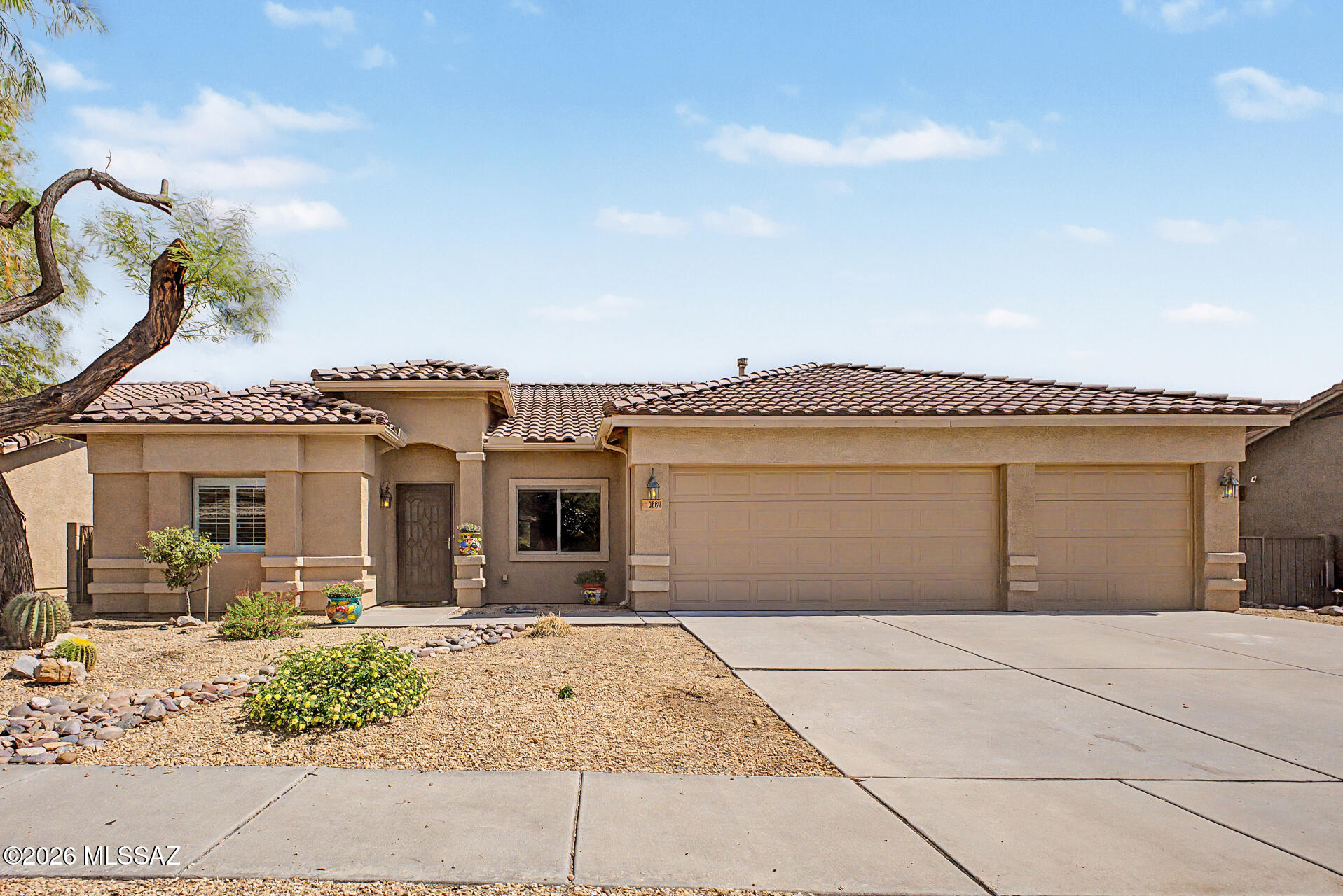 3664 East Northern Dancer Road Tucson, AZ 85739 - Photo 2 of 42 Front Exterior with Long Driveway and 3 Car Garage