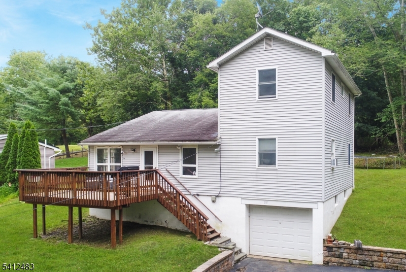 62 Ridgeway Avenue Blairstown, NJ 07825 - Photo 1 of 11 a view of a house with a yard chairs and table