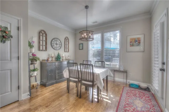 a view of a dining room with furniture window and wooden floor