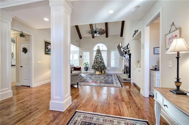 a view of a hallway view with wooden floor and staircase