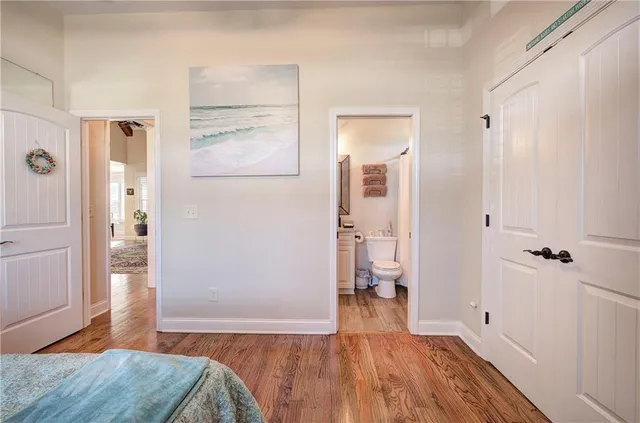 a view of a room with wooden floor and a bathroom