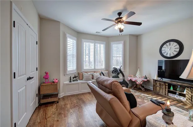 a living room with furniture a chandelier and a window
