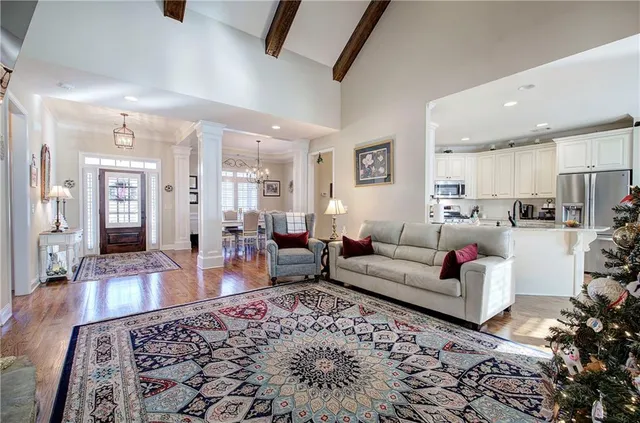 a living room with furniture wooden floor and a rug