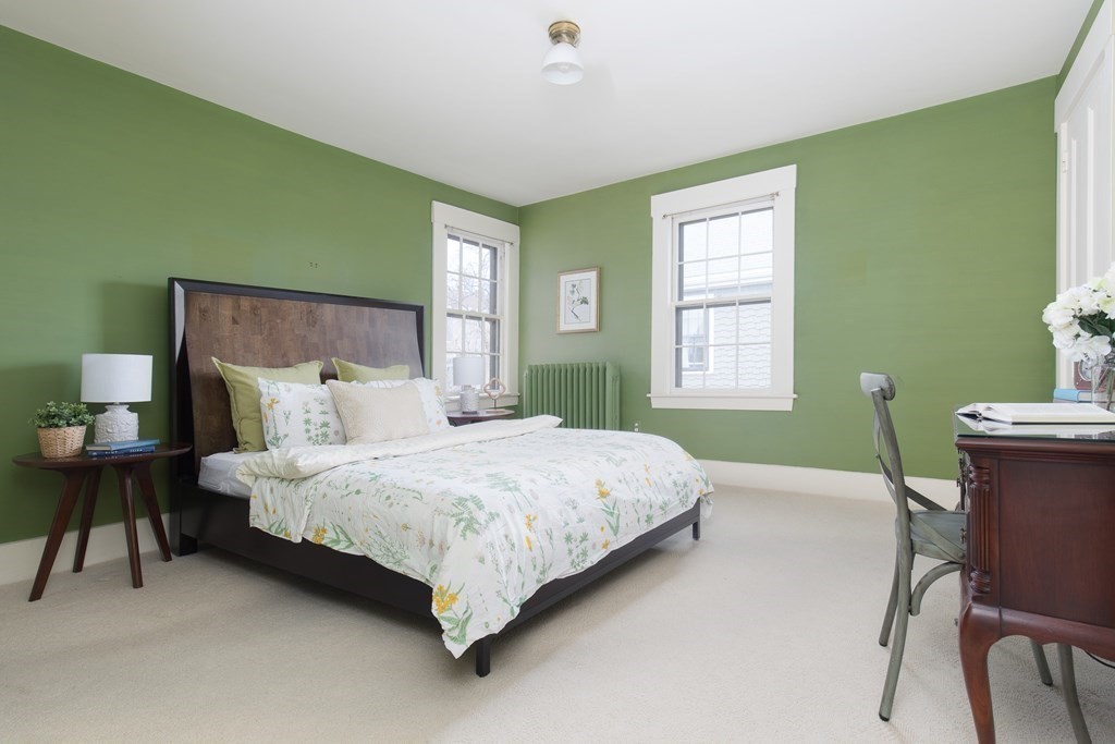 13 Yerxa Road Cambridge, MA 02140 - Photo 16 of 24 a bedroom with a bed and a table