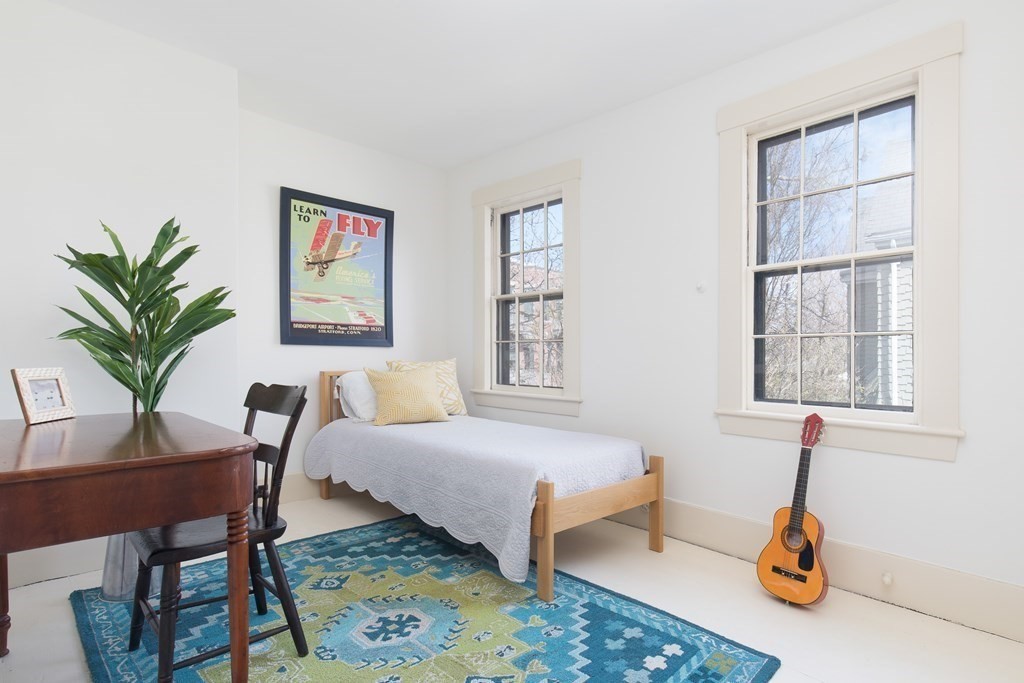 13 Yerxa Road Cambridge, MA 02140 - Photo 17 of 24 a bedroom with a bed a table and chair