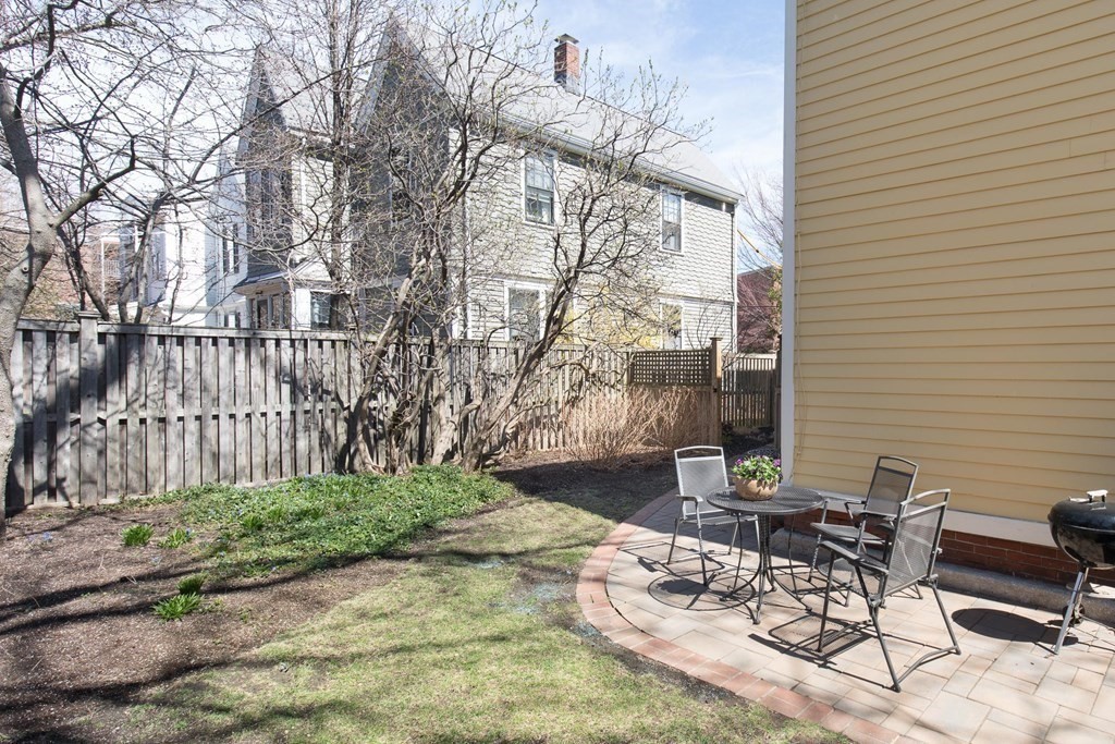 13 Yerxa Road Cambridge, MA 02140 - Photo 24 of 24 a view of a patio with table and chairs and wooden fence