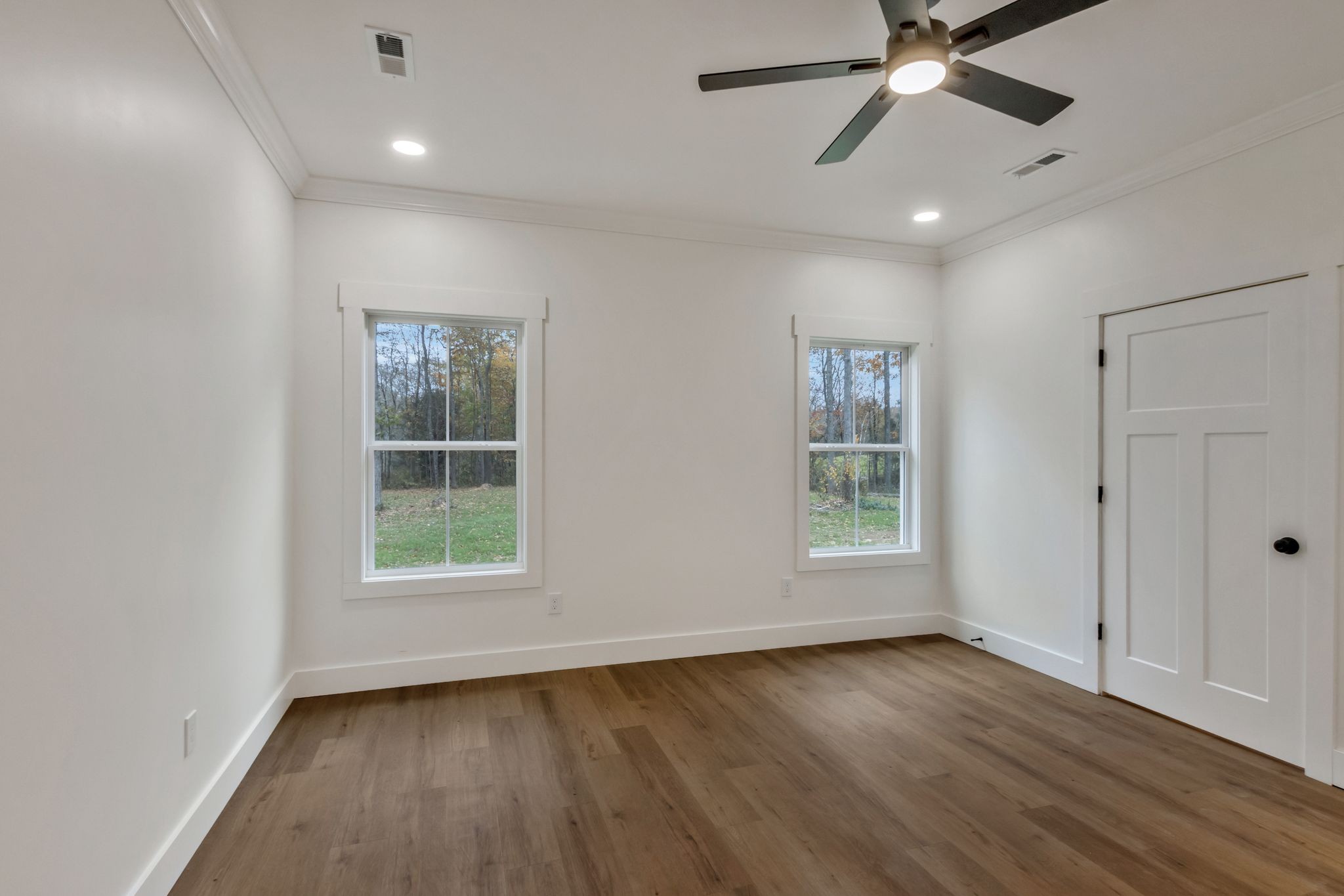 482 Boswell Road Winchester, TN 37398 - Photo 15 of 36 an empty room with wooden floor fan and windows
