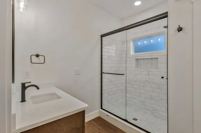 a bathroom with a sink and shower