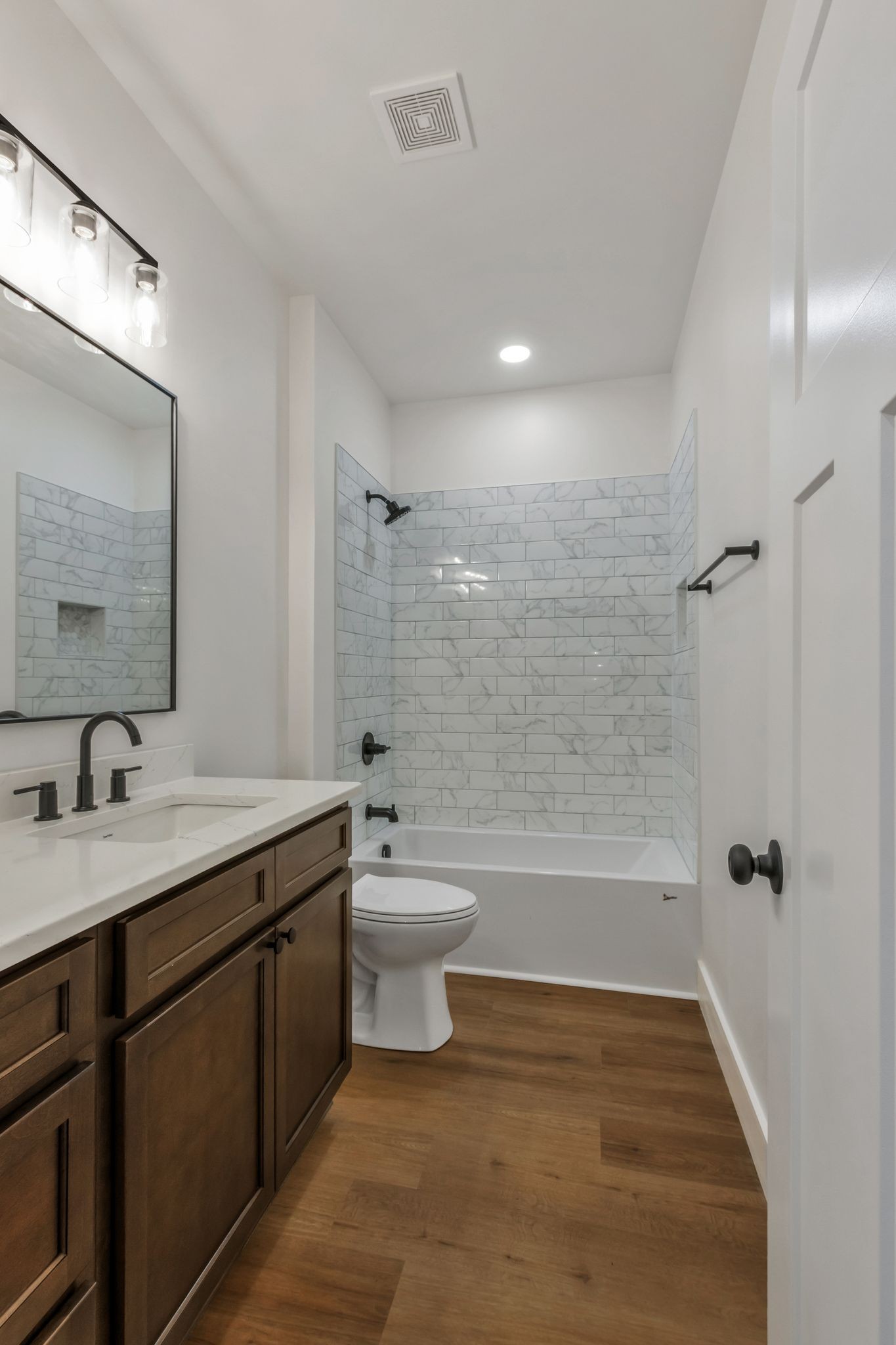 482 Boswell Road Winchester, TN 37398 - Photo 27 of 36 a bathroom with a granite countertop sink a toilet a mirror a bathtub and shower