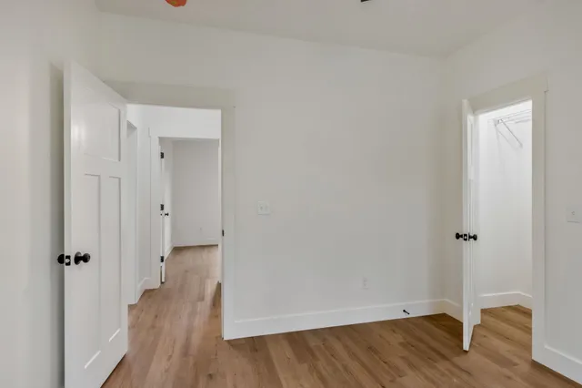 a view of a hallway with wooden floor
