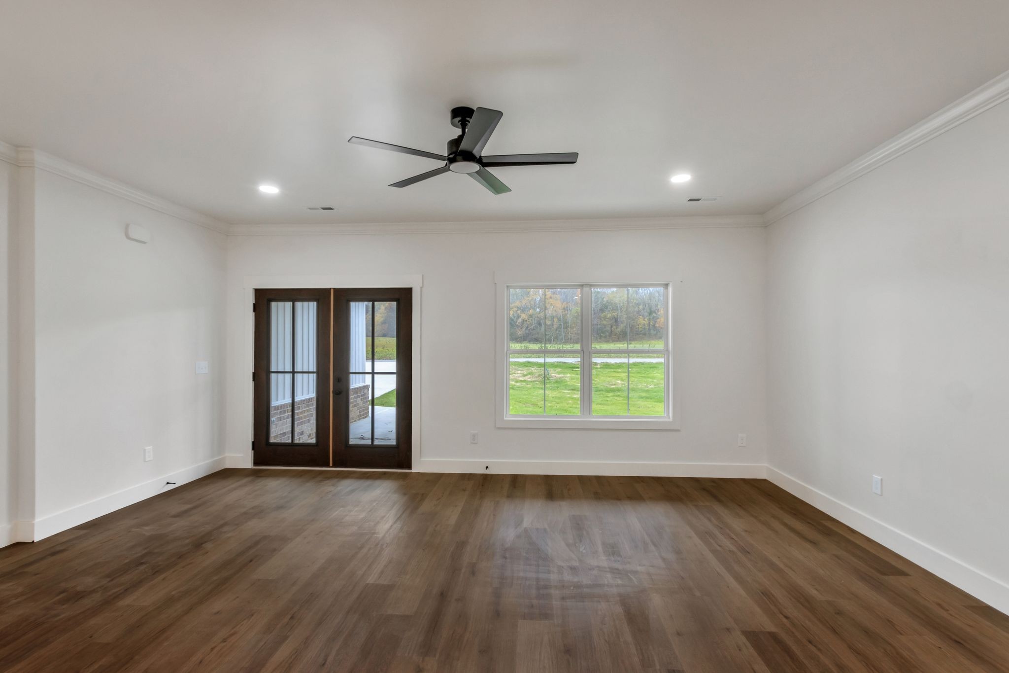 482 Boswell Road Winchester, TN 37398 - Photo 5 of 36 an empty room with wooden floor and windows