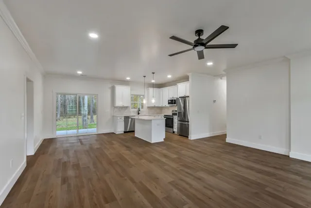 a view of a kitchen with a sink and wooden floor