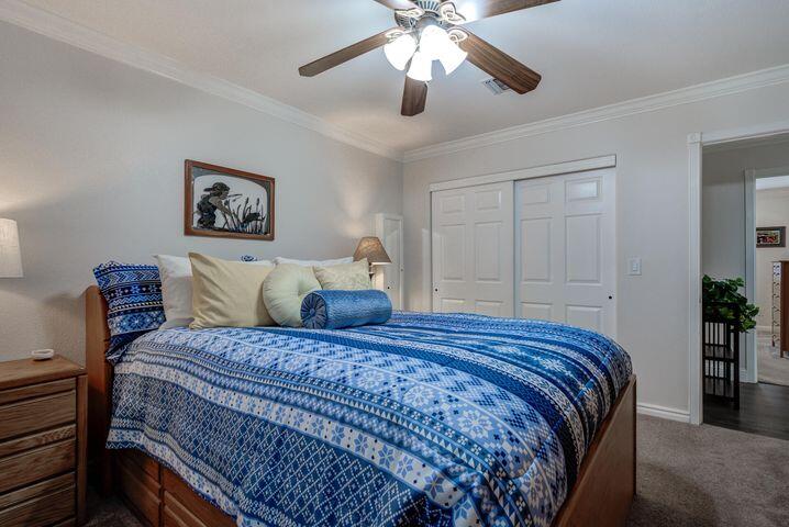 37105 Sapphire Road Burney, CA 96013 - Photo 24 of 39 a bedroom with bed and a chandelier