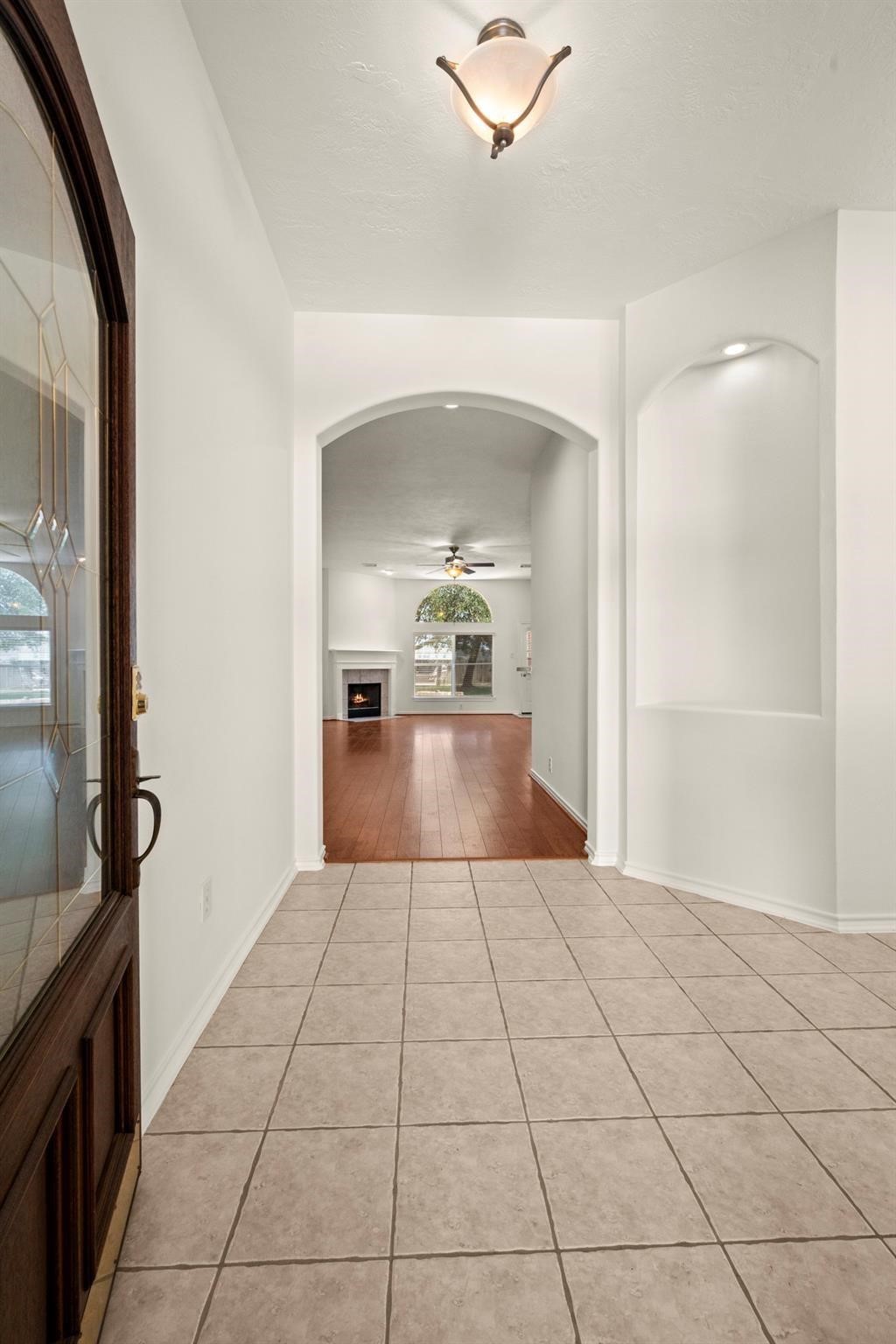 21014 Jessica Rose Lane Spring, TX 77379 - Photo 2 of 30 a view of a hallway view with wooden floor and staircase