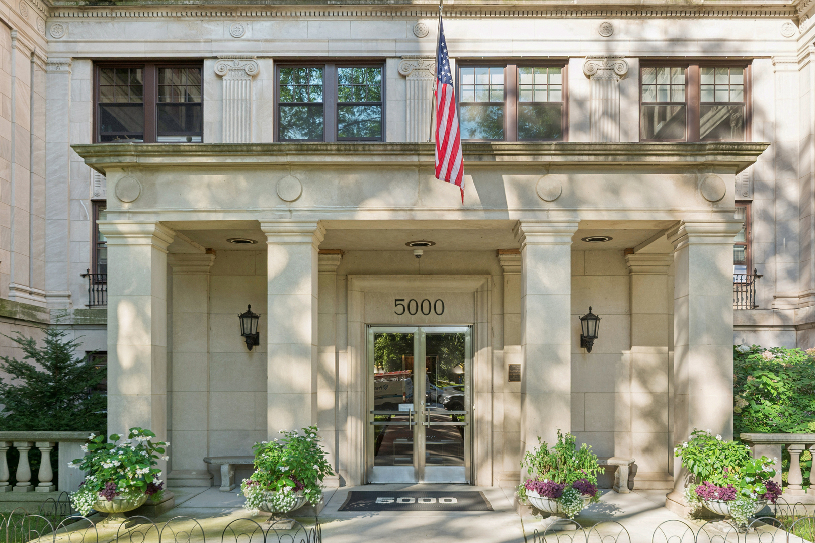 front view of a house with a potted plant and windows