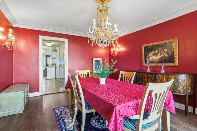 a view of a dining room with furniture and chandelier