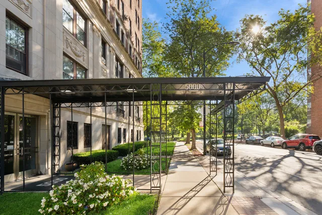 a view of a building with a bench in patio