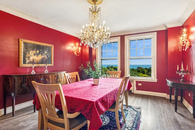 a view of a dining room with furniture a chandelier and wooden floor