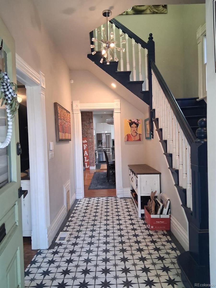 451 Acoma Street Denver, CO 80204 - Photo 11 of 19 a view of a hallway with wooden floor and staircase