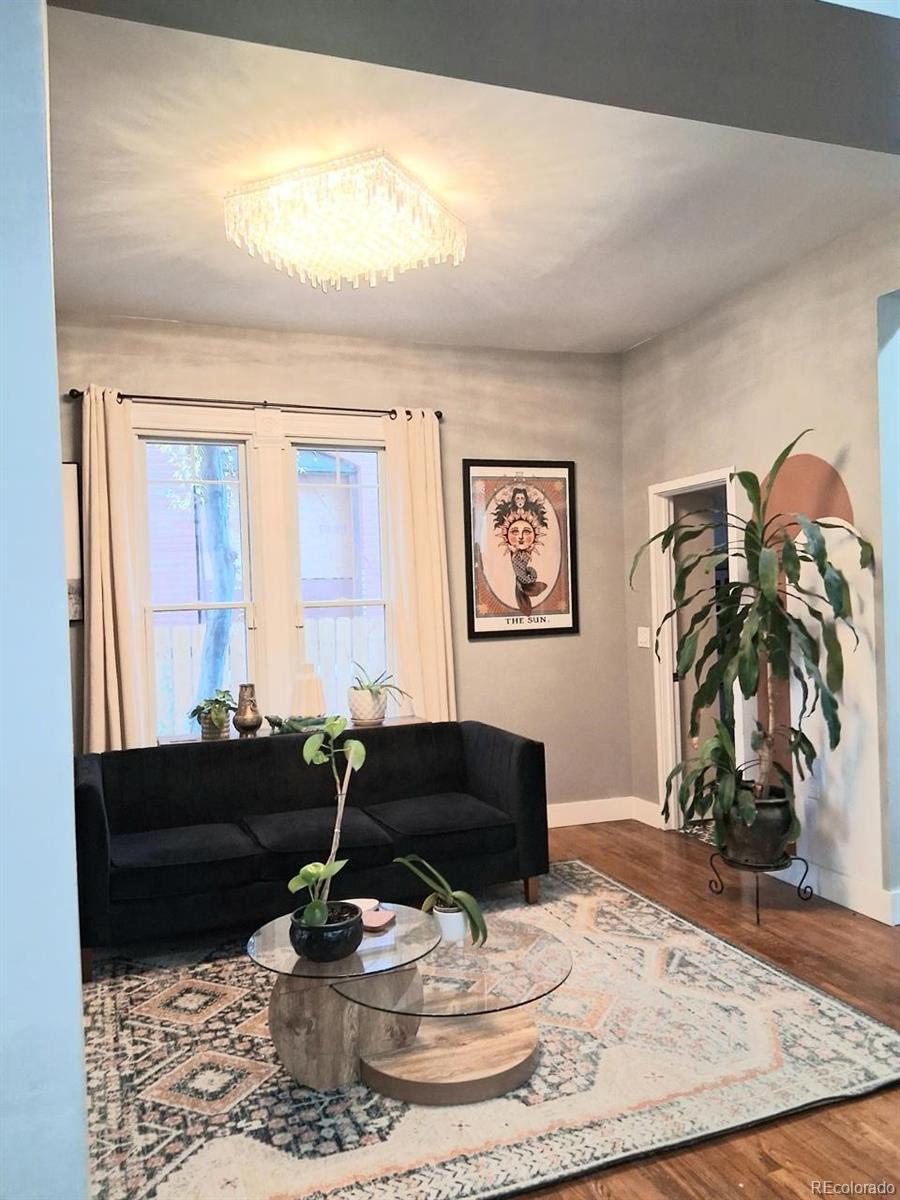 451 Acoma Street Denver, CO 80204 - Photo 15 of 19 a living room with furniture and a dining table