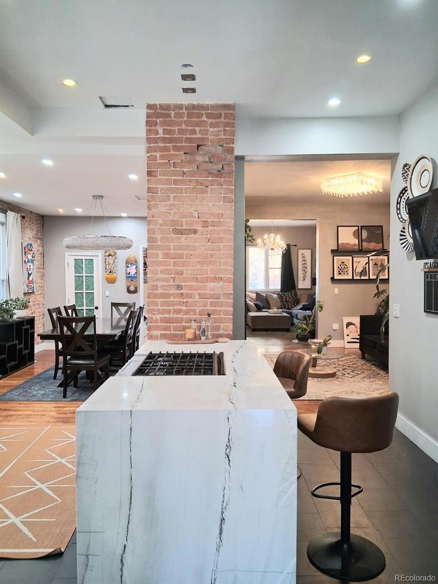 451 Acoma Street Denver, CO 80204 - Photo 6 of 19 a living room with furniture and a chandelier