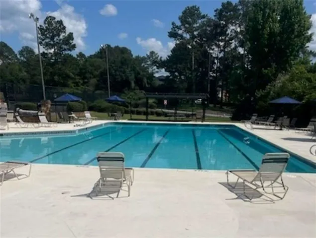 an aerial view of residential houses with outdoor space and trees