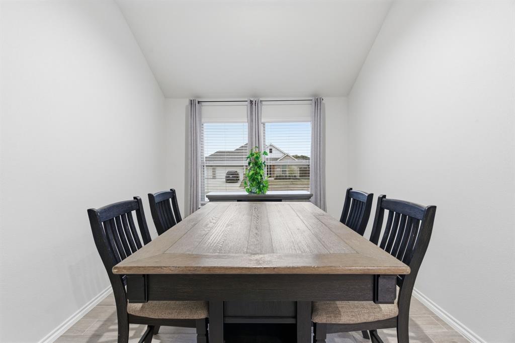 437 Falcon Way Azle, TX 76020 - Photo 14 of 40 a view of a dining room with furniture a potted plant and wooden floor