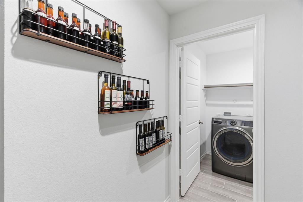 437 Falcon Way Azle, TX 76020 - Photo 17 of 40 a view of a hallway with washer and dryer
