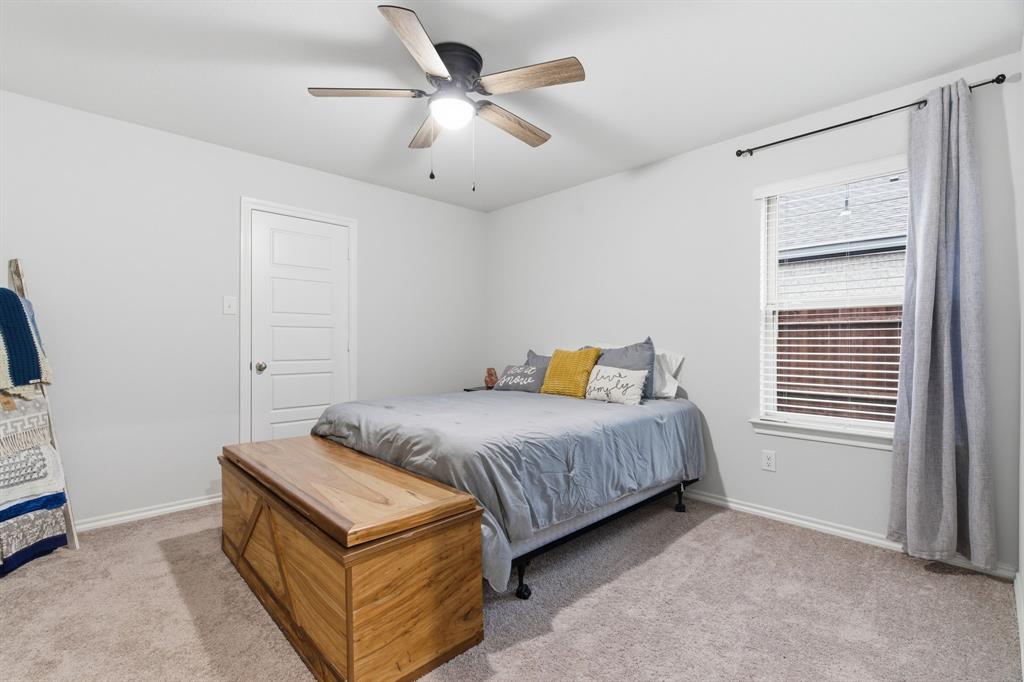 437 Falcon Way Azle, TX 76020 - Photo 19 of 40 a bedroom with a bed and a ceiling fan