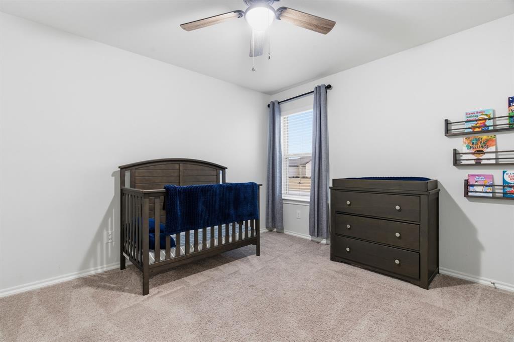 437 Falcon Way Azle, TX 76020 - Photo 21 of 40 a room with a baby crib and a dresser