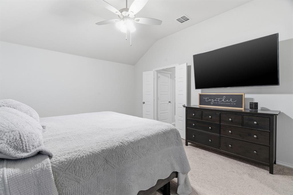 437 Falcon Way Azle, TX 76020 - Photo 23 of 40 a bedroom with a bed and a flat screen tv