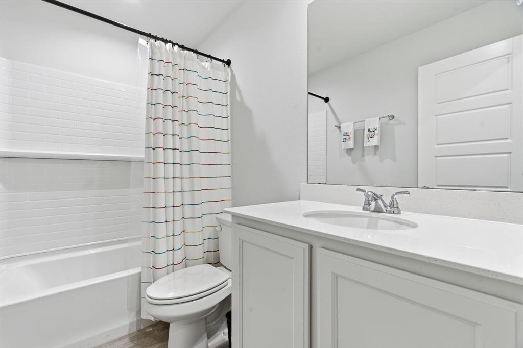 437 Falcon Way Azle, TX 76020 - Photo 24 of 40 a bathroom with a sink toilet and shower