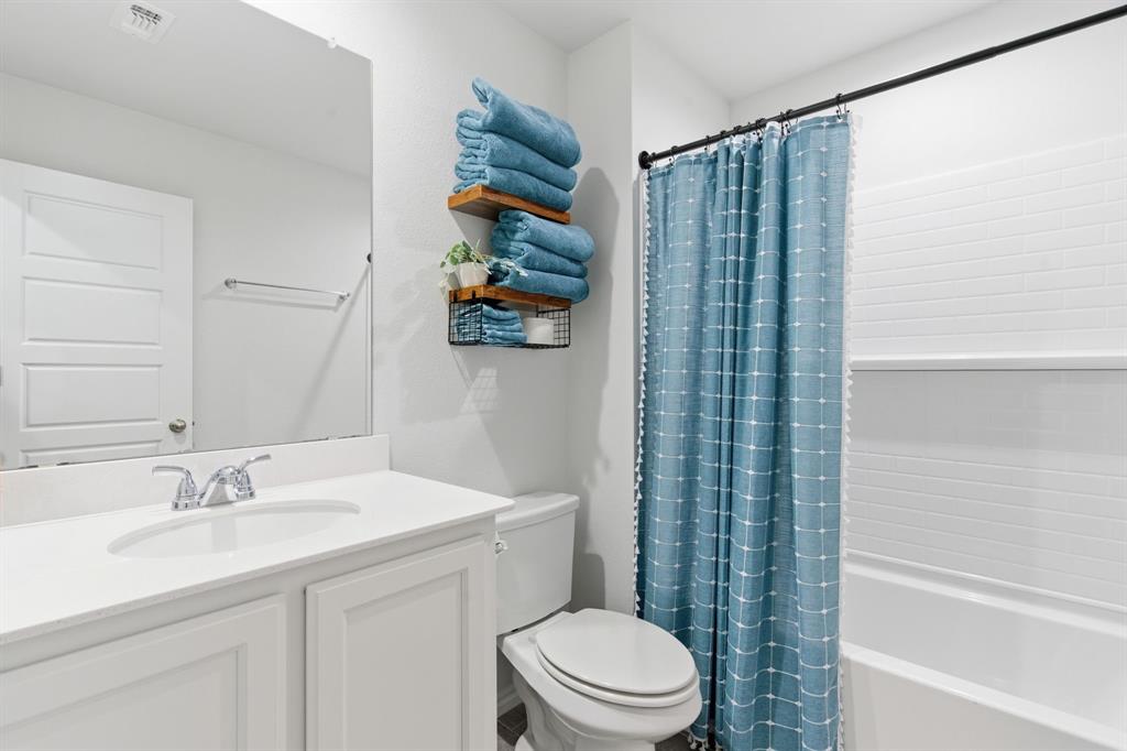 437 Falcon Way Azle, TX 76020 - Photo 25 of 40 a bathroom with a sink a toilet and shower