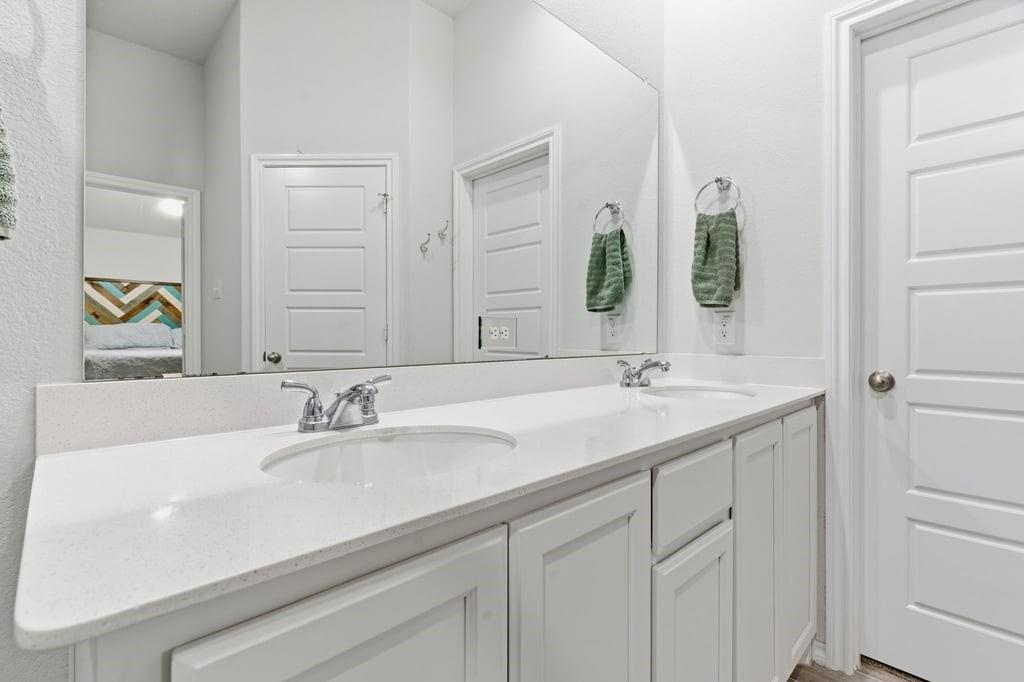 437 Falcon Way Azle, TX 76020 - Photo 29 of 40 a bathroom with a sink and a mirror